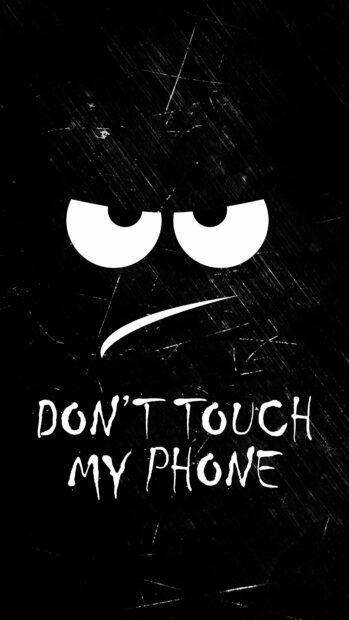 Angry eyes with sharp mouth and dont touch my phone text on black textured background