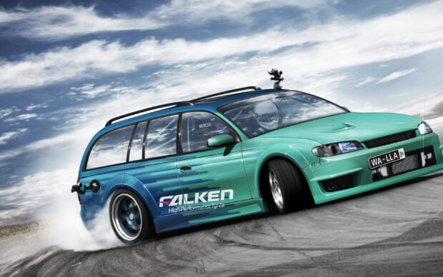 A speeding car drifting on a race track with Falken logo on its side