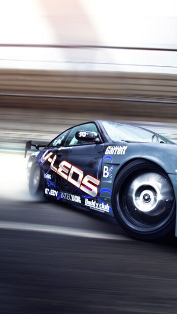 A drifting car showcasing intense drifting action on a wet track