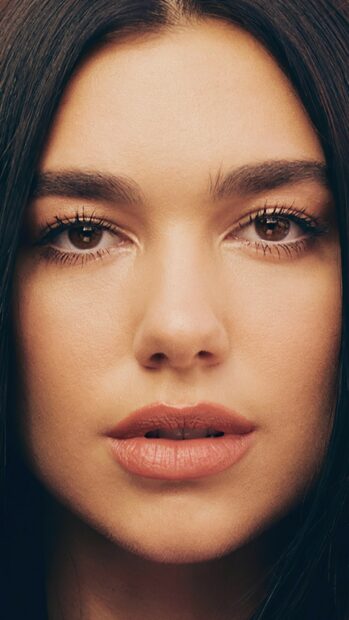 Close up of Dua Lipa with detailed features and natural makeup