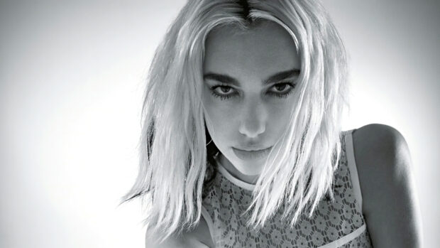 Close up of Dua Lipa in a lace top with wet hair looking intense in black and white