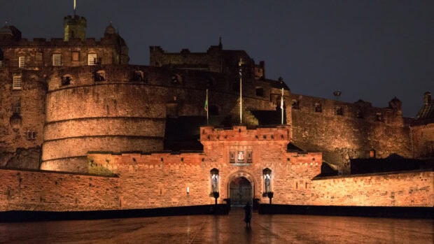 Edinburgh Castle historic fortress illuminated at night with clear sky