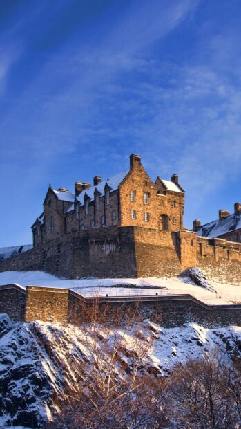 Historic Edinburgh Castle covered with snow on a winter day