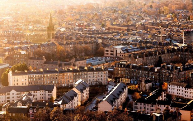 Aerial view of old stone buildings in Edinburgh Scotland during golden hour autumn light