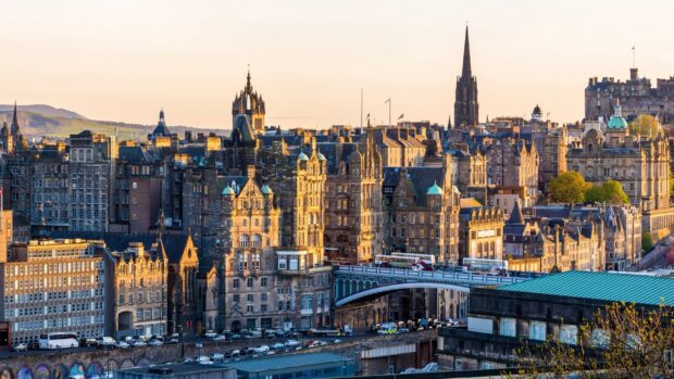 Historic Edinburgh Scotland cityscape with old stone buildings and bridges at sunset