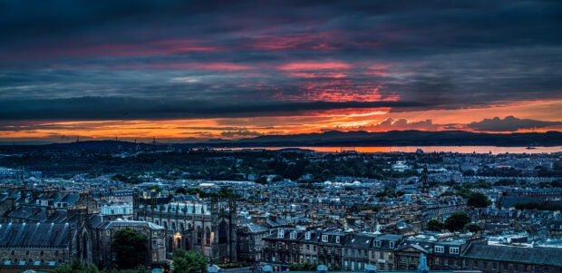 Historic buildings of Edinburgh Scotland at sunset with colorful sky