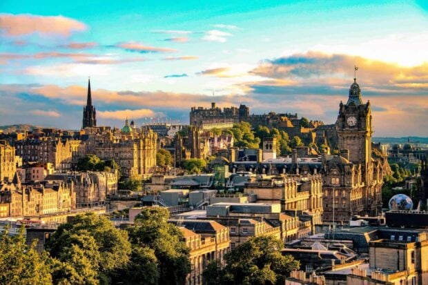Historic Edinburgh Scotland cityscape with castle and clock tower at sunset