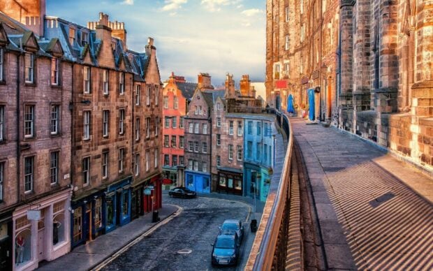 Charming old buildings on a cobblestone street in Edinburgh Scotland