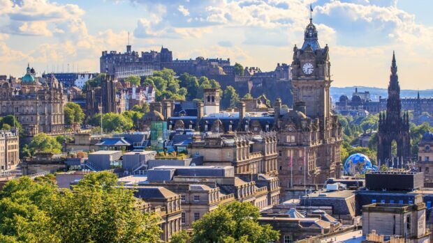 A beautiful view of Edinburgh Scotland cityscape with historic buildings and lush greenery