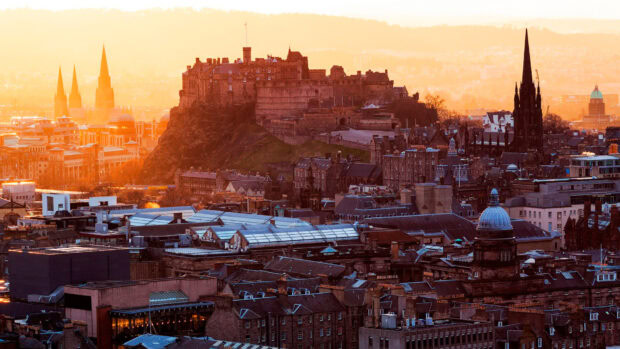 Edinburgh Scotland castle and cityscape at sunset with historic buildings and spires