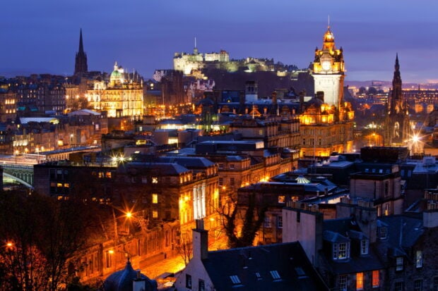 Edinburgh Scotland cityscape with historic buildings lit up at night showcasing urban architecture