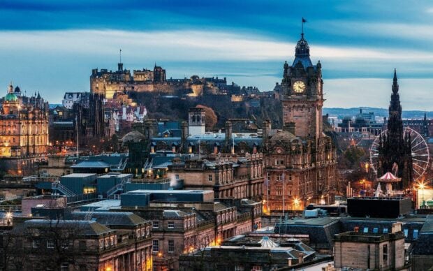 Edinburgh Scotland skyline at dusk with historic buildings and castle illuminated