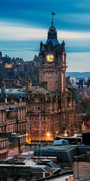 Historic Edinburgh Scotland cityscape with clock tower at dusk
