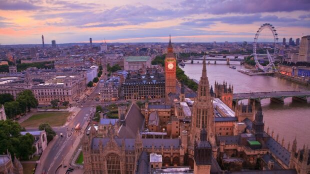 The iconic England cityscape with Big Ben and the London Eye at sunset in high definition