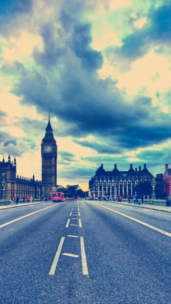 Dramatic sky over England clock tower on a busy London street