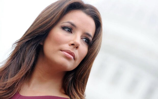 Eva Longoria looking thoughtfully with natural makeup and long hair