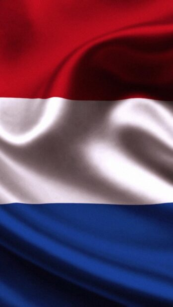 The Netherlands flag with red white and blue horizontal stripes on fabric waves