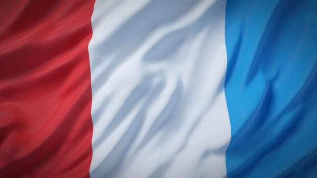 The French flag waving in high quality fabric texture with red white and blue stripes