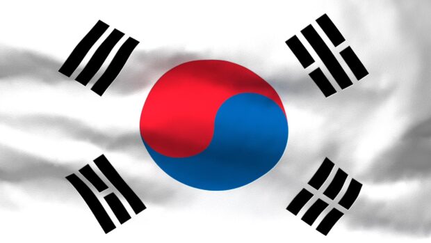 Waving South Korea flag symbol with red and blue yin yang at the center on white background