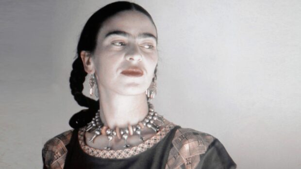 A portrait of Frida Kahlo wearing traditional jewelry and looking to the side