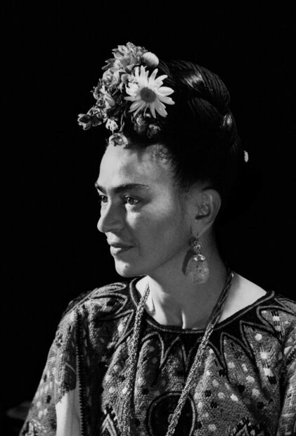 Frida Kahlo portrait with floral headpiece and intricate clothing in black and white