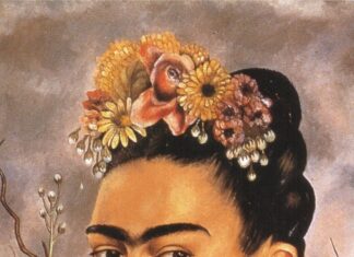 A portrait of Frida Kahlo wearing floral headpiece and unique hand earrings