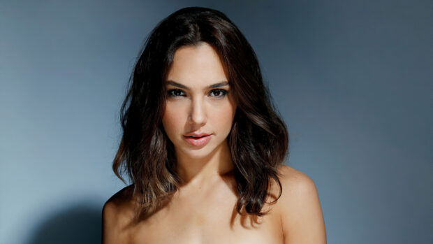 Gal Gadot close up portrait with shoulder length hair and neutral background