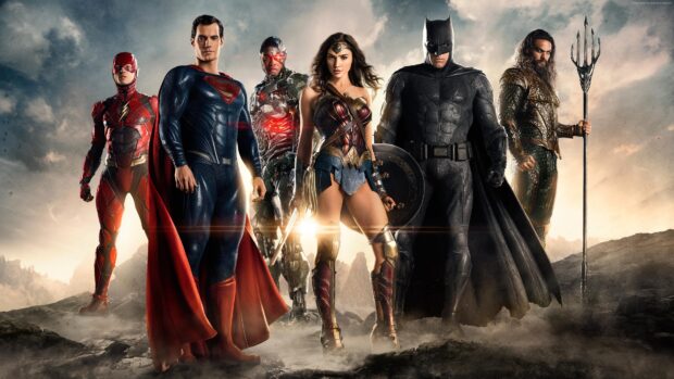 Gal Gadot standing with Justice League heroes in a dramatic landscape scene