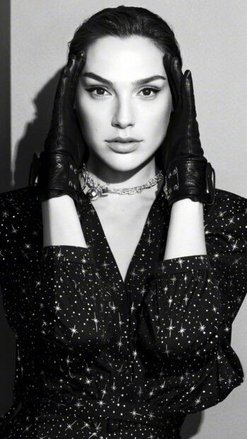 Gal Gadot wearing black gloves and a star patterned outfit in a stylish portrait