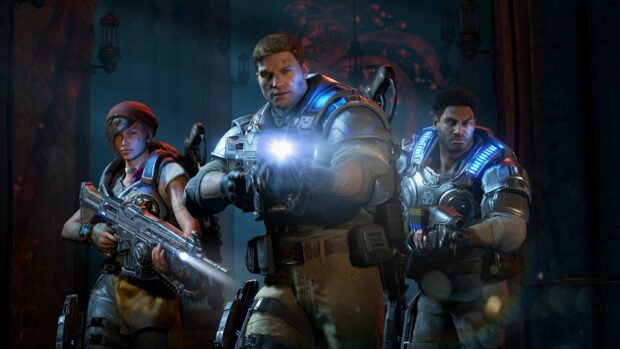 Three Gears Of War characters holding weapons and preparing for battle in a dark corridor