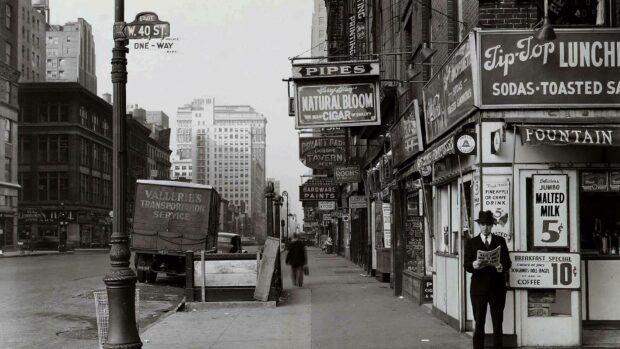 Gentleman standing on a city street reading a newspaper in vintage style