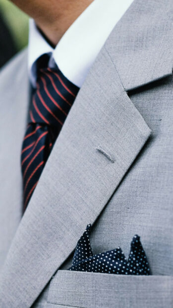 Close up of gentleman wearing elegant suit and tie with pocket square