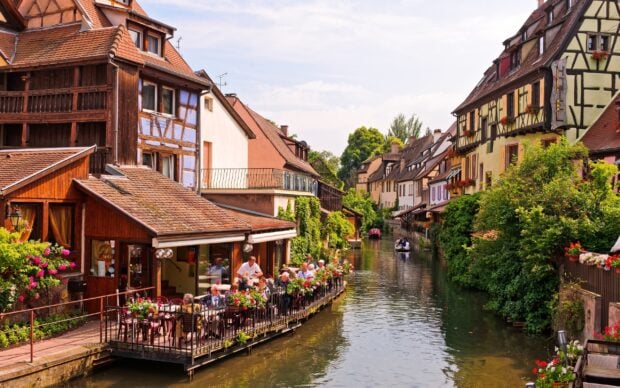 A charming canal town with traditional architecture and vibrant greenery in geography scene