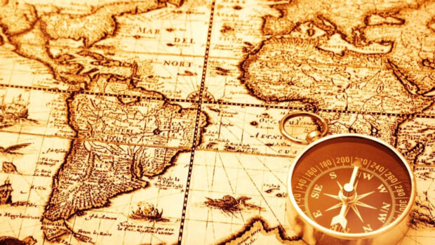 Antique map showing geography with a compass placed on top of it