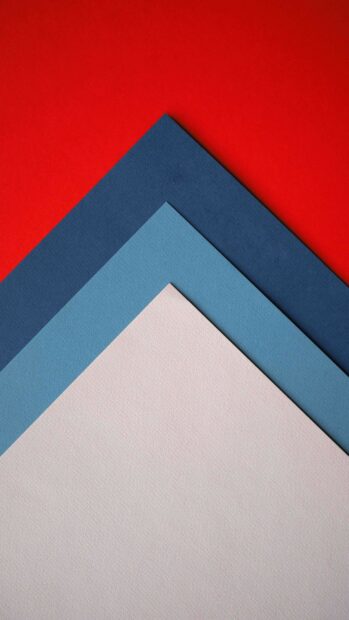 Layered geometric shapes with blue and red tones creating a clean geometric composition