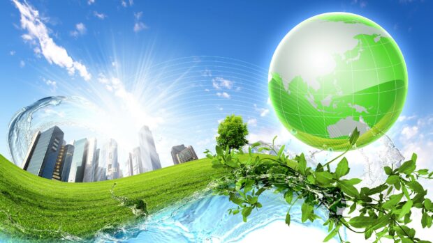 Green earth concept with plants and city skyline under a clear blue sky
