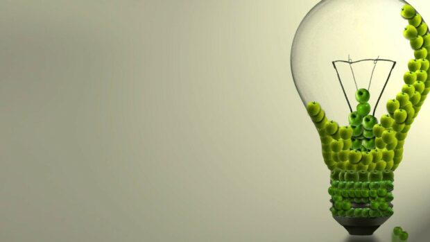 A creative design of a light bulb made with green apples showing go green concept