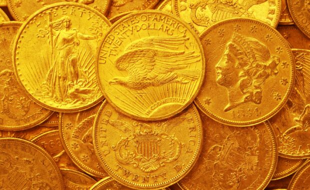 Close up of gold coins showing eagle and liberty designs in high detail