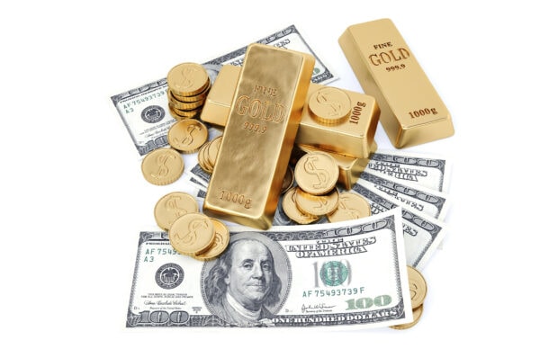 Stack of gold coins and gold bars with hundred dollar bills on white background