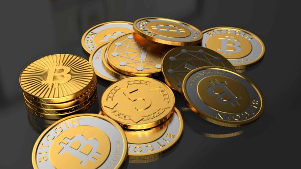 High quality gold coins featuring bitcoin and cryptocurrency symbols on a dark surface