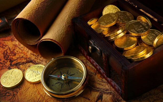 A treasure chest filled with gold coins next to a compass and old scrolls on a map