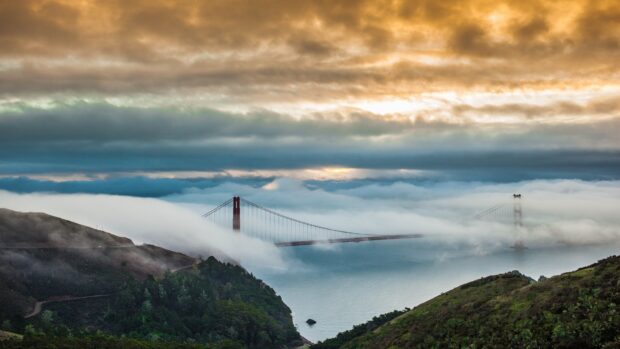 Morning fog surrounds the Golden Gate Bridge in San Francisco creating a scenic view