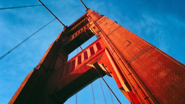 Close up view of the Golden Gate Bridge structure under clear blue sky