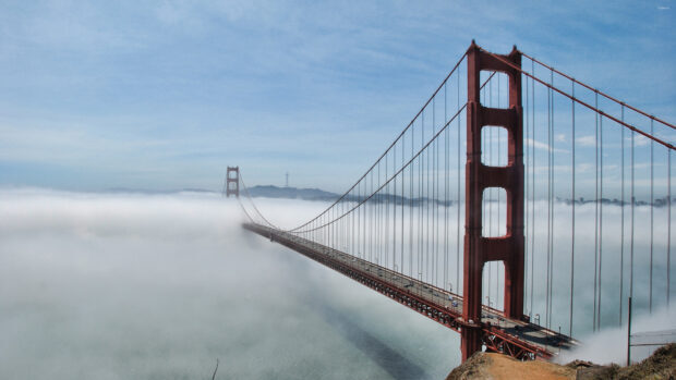 Golden Gate Bridge with fog surrounding the structure over the water