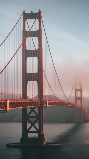The Golden Gate Bridge captured with fog in the background at sunset