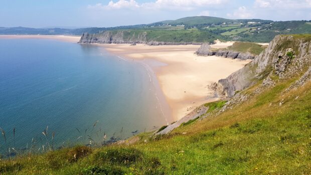 Scenic view of Gower Peninsula coastline with cliffs and sandy beach
