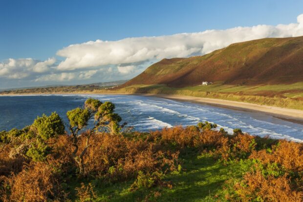The scenic view of Gower Peninsula with coastal hills and shoreline in natural landscape