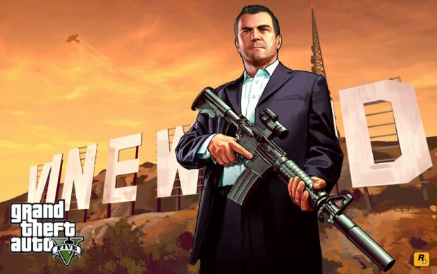 Michael from Grand Theft Auto 5 holding a rifle in front of the Vinewood sign at sunset