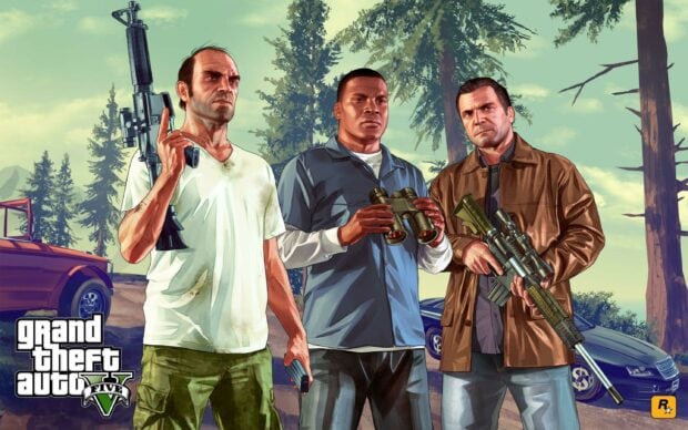 The main characters in Grand Theft Auto 5 hold weapons in a forest setting with vehicles in the background