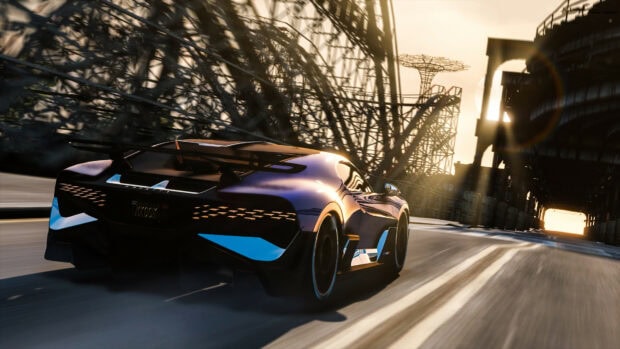 A sleek car from Grand Theft Auto 5 driving fast on an urban road during sunset